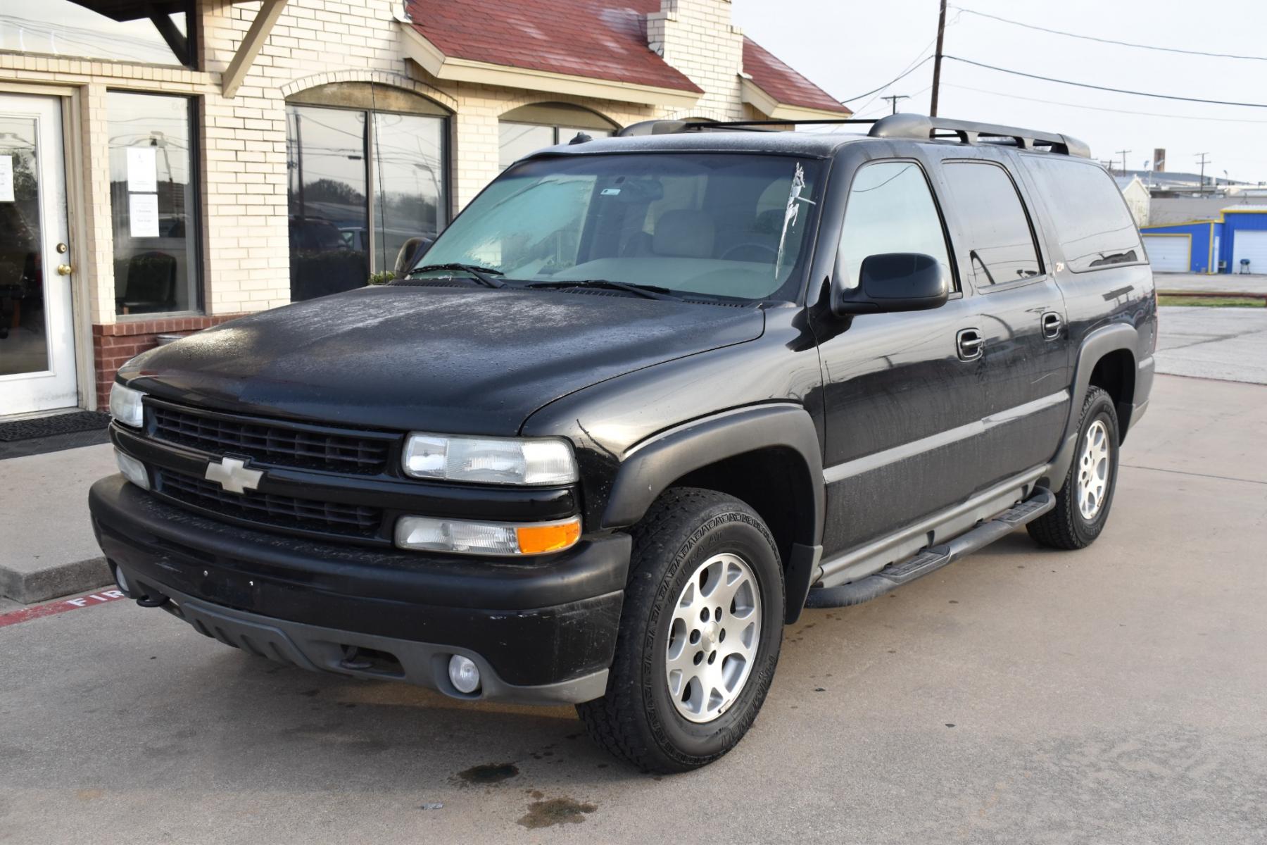2003 Black /Beige Chevrolet Suburban 1500 4WD (3GNFK16Z13G) with an 5.3L V8 OHV 16V FFV engine, 4-Speed Automatic Overdrive transmission, located at 5925 E. BELKNAP ST., HALTOM CITY, TX, 76117, (817) 834-4222, 32.803799, -97.259003 - [Scene: A picturesque suburban neighborhood on a sunny day. The camera pans through lush lawns and beautiful homes.] Narrator (V.O.): Welcome to the heart of the suburbs, where life is all about family, adventure, and making memories that last a lifetime. [Cut to a driveway, where a well-maintaine - Photo #1
