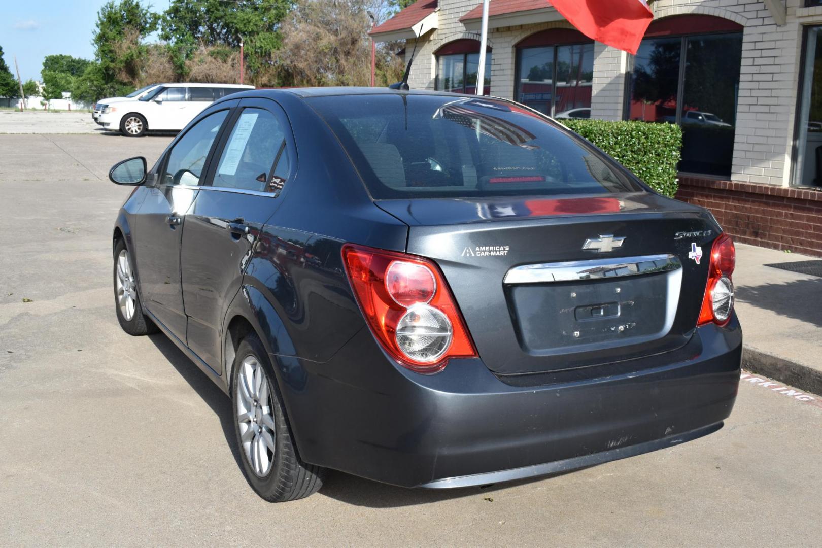 2012 Black /Gray Chevrolet Sonic (1G1JC5SH9C4) with an 4.1.8L engine, 6-Speed Automatic transmission, located at 5925 E. BELKNAP ST., HALTOM CITY, TX, 76117, (817) 834-4222, 32.803799, -97.259003 - The 2012 Chevrolet Sonic offers several benefits. Here are a few: 1. Fuel Efficiency: The Sonic is known for its impressive fuel efficiency, making it a cost-effective choice for daily commuting and long drives. 2. Compact Size: The Sonic's compact size makes it easy to maneuver in tight city stre - Photo#1