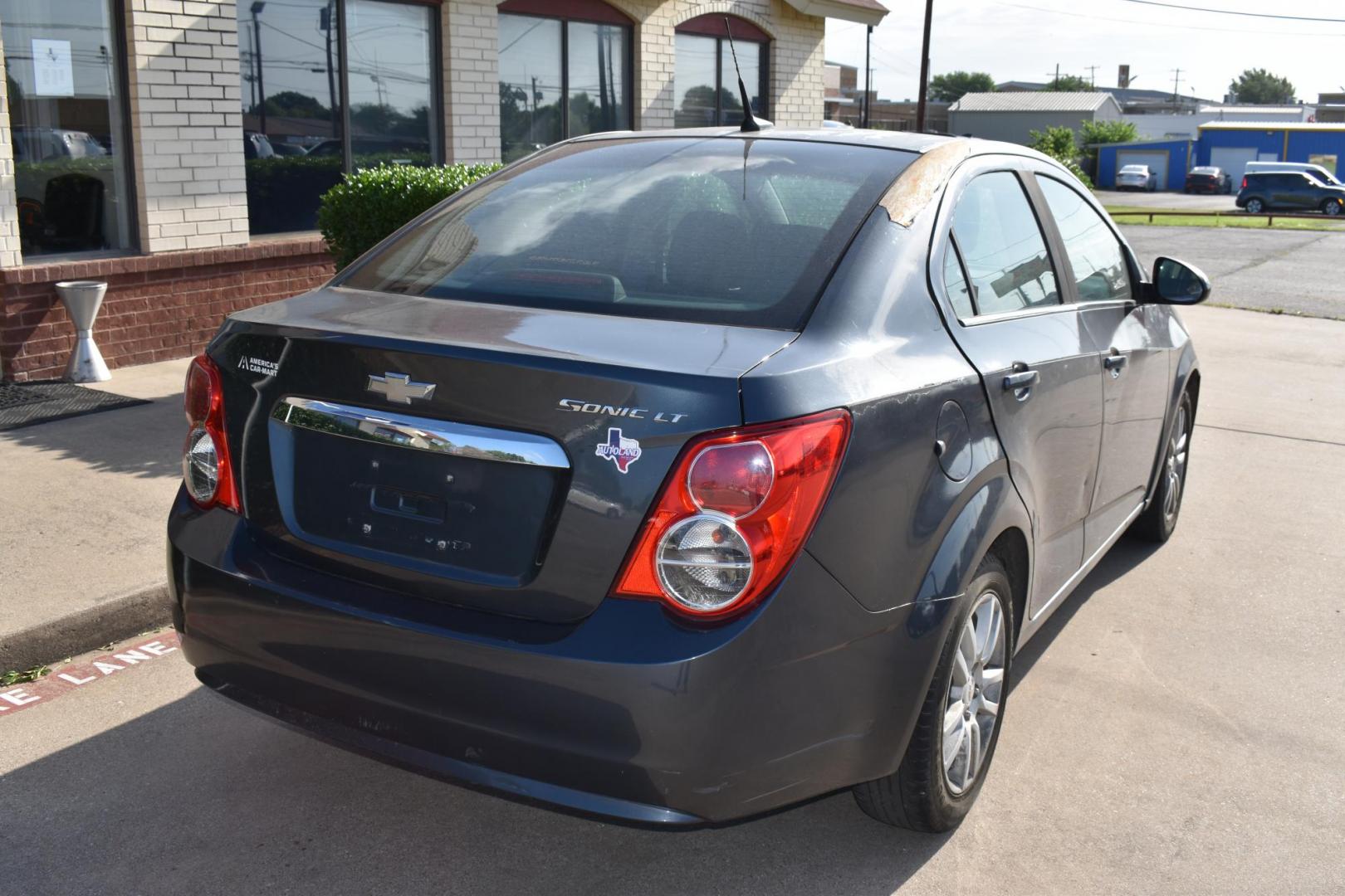 2012 Black /Gray Chevrolet Sonic (1G1JC5SH9C4) with an 4.1.8L engine, 6-Speed Automatic transmission, located at 5925 E. BELKNAP ST., HALTOM CITY, TX, 76117, (817) 834-4222, 32.803799, -97.259003 - The 2012 Chevrolet Sonic offers several benefits. Here are a few: 1. Fuel Efficiency: The Sonic is known for its impressive fuel efficiency, making it a cost-effective choice for daily commuting and long drives. 2. Compact Size: The Sonic's compact size makes it easy to maneuver in tight city stre - Photo#3
