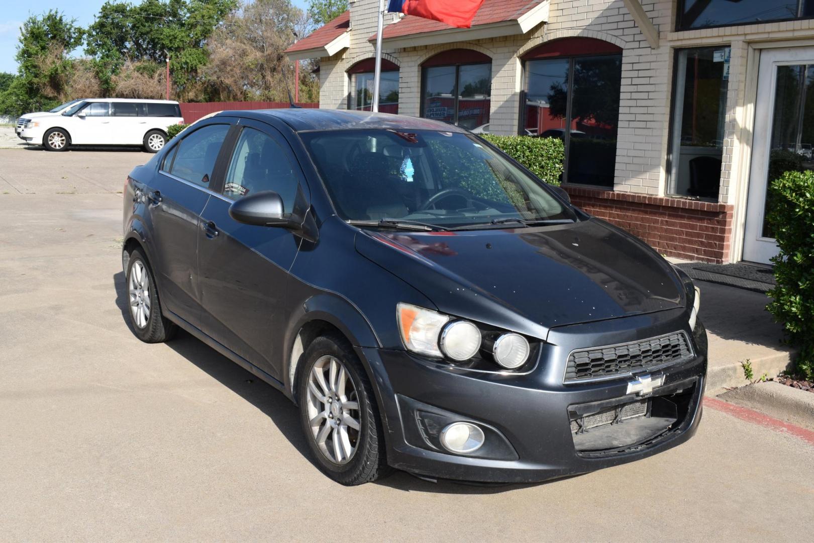 2012 Black /Gray Chevrolet Sonic (1G1JC5SH9C4) with an 4.1.8L engine, 6-Speed Automatic transmission, located at 5925 E. BELKNAP ST., HALTOM CITY, TX, 76117, (817) 834-4222, 32.803799, -97.259003 - The 2012 Chevrolet Sonic offers several benefits. Here are a few: 1. Fuel Efficiency: The Sonic is known for its impressive fuel efficiency, making it a cost-effective choice for daily commuting and long drives. 2. Compact Size: The Sonic's compact size makes it easy to maneuver in tight city stre - Photo#4