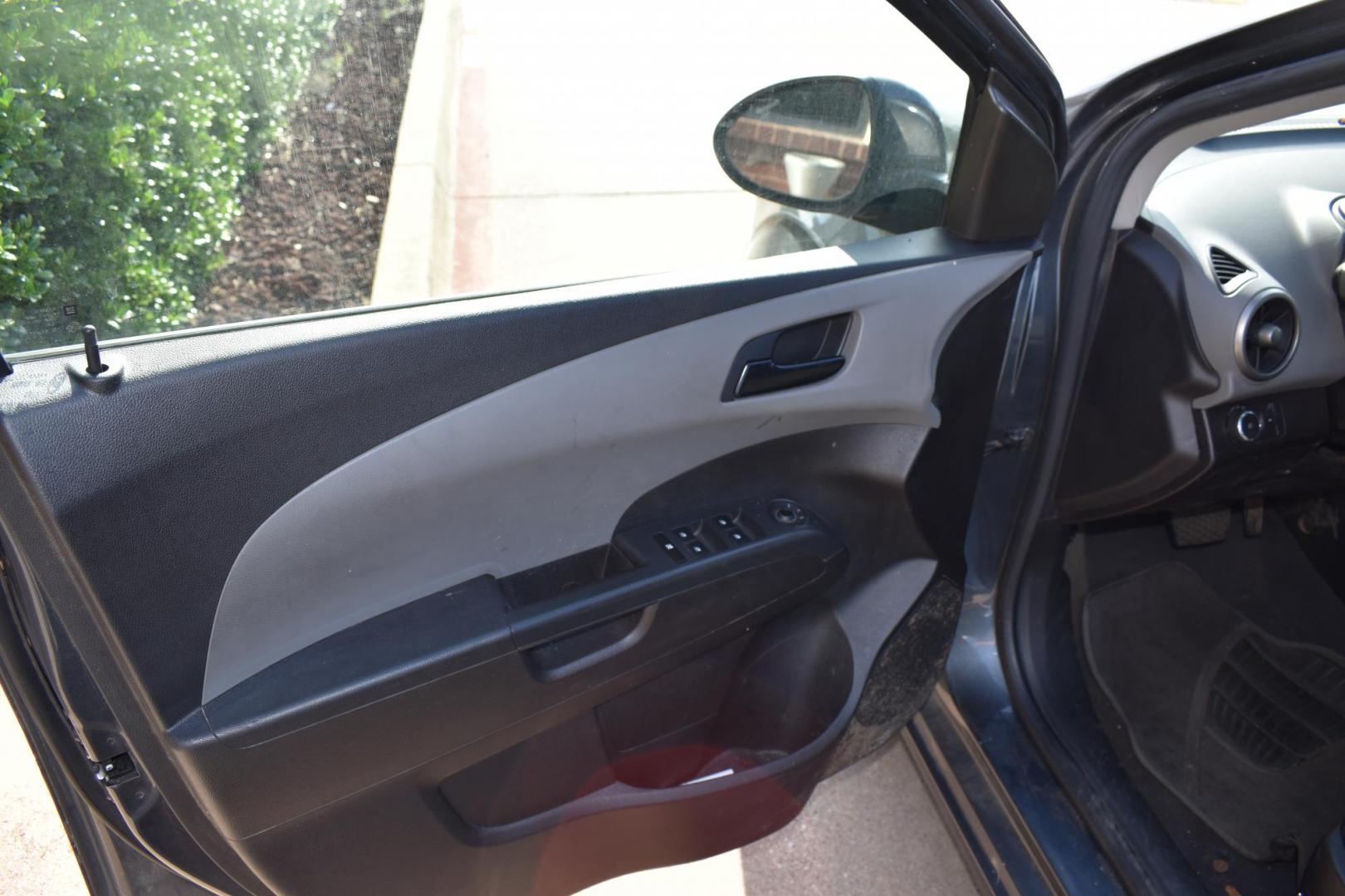 2012 Black /Gray Chevrolet Sonic (1G1JC5SH9C4) with an 4.1.8L engine, 6-Speed Automatic transmission, located at 5925 E. BELKNAP ST., HALTOM CITY, TX, 76117, (817) 834-4222, 32.803799, -97.259003 - The 2012 Chevrolet Sonic offers several benefits. Here are a few: 1. Fuel Efficiency: The Sonic is known for its impressive fuel efficiency, making it a cost-effective choice for daily commuting and long drives. 2. Compact Size: The Sonic's compact size makes it easy to maneuver in tight city stre - Photo#5