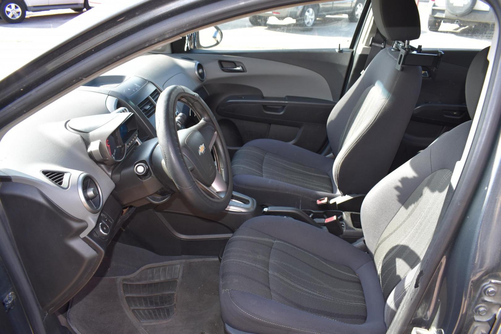 2012 Black /Gray Chevrolet Sonic (1G1JC5SH9C4) with an 4.1.8L engine, 6-Speed Automatic transmission, located at 5925 E. BELKNAP ST., HALTOM CITY, TX, 76117, (817) 834-4222, 32.803799, -97.259003 - The 2012 Chevrolet Sonic offers several benefits. Here are a few: 1. Fuel Efficiency: The Sonic is known for its impressive fuel efficiency, making it a cost-effective choice for daily commuting and long drives. 2. Compact Size: The Sonic's compact size makes it easy to maneuver in tight city stre - Photo#6