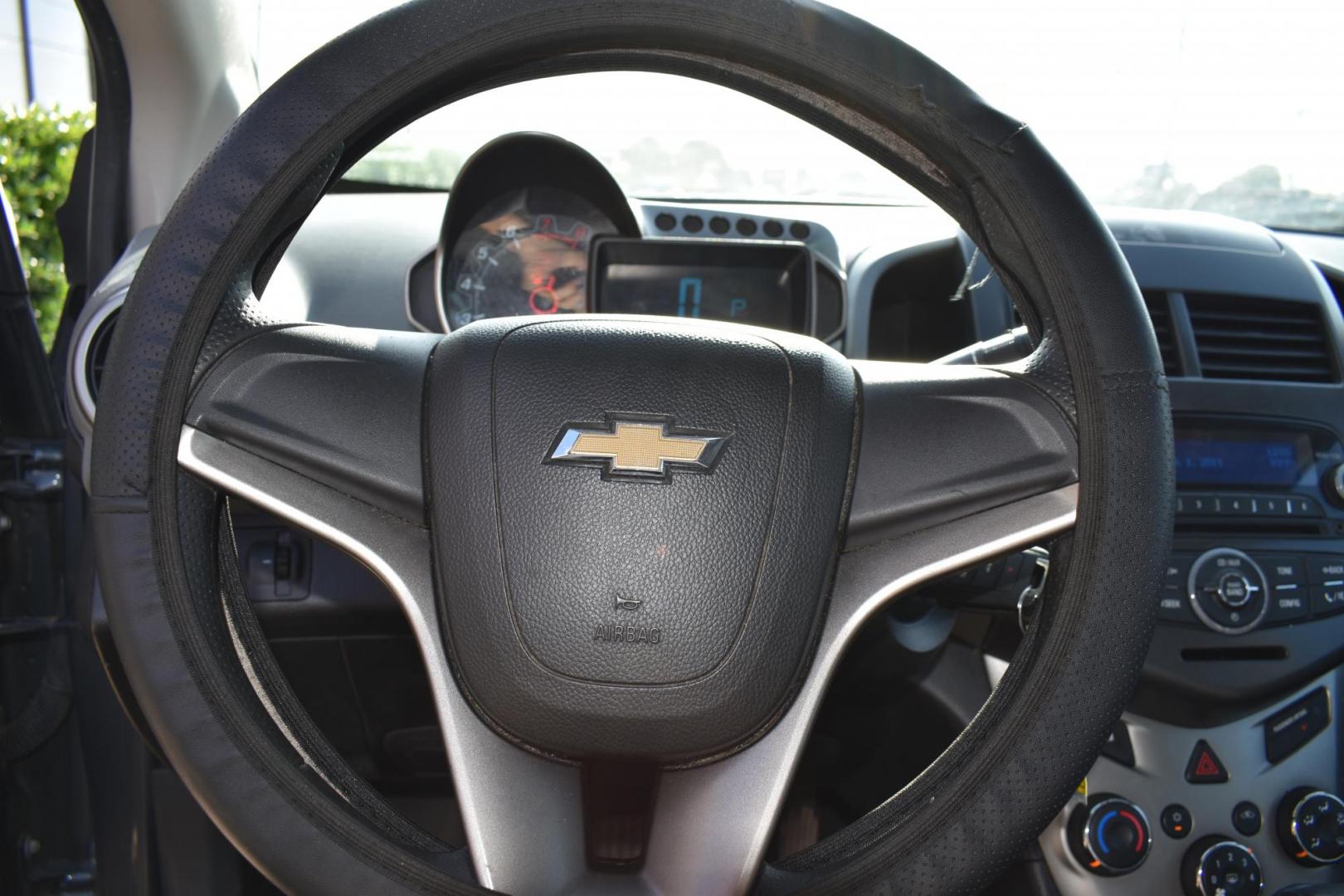 2012 Black /Gray Chevrolet Sonic (1G1JC5SH9C4) with an 4.1.8L engine, 6-Speed Automatic transmission, located at 5925 E. BELKNAP ST., HALTOM CITY, TX, 76117, (817) 834-4222, 32.803799, -97.259003 - The 2012 Chevrolet Sonic offers several benefits. Here are a few: 1. Fuel Efficiency: The Sonic is known for its impressive fuel efficiency, making it a cost-effective choice for daily commuting and long drives. 2. Compact Size: The Sonic's compact size makes it easy to maneuver in tight city stre - Photo#9