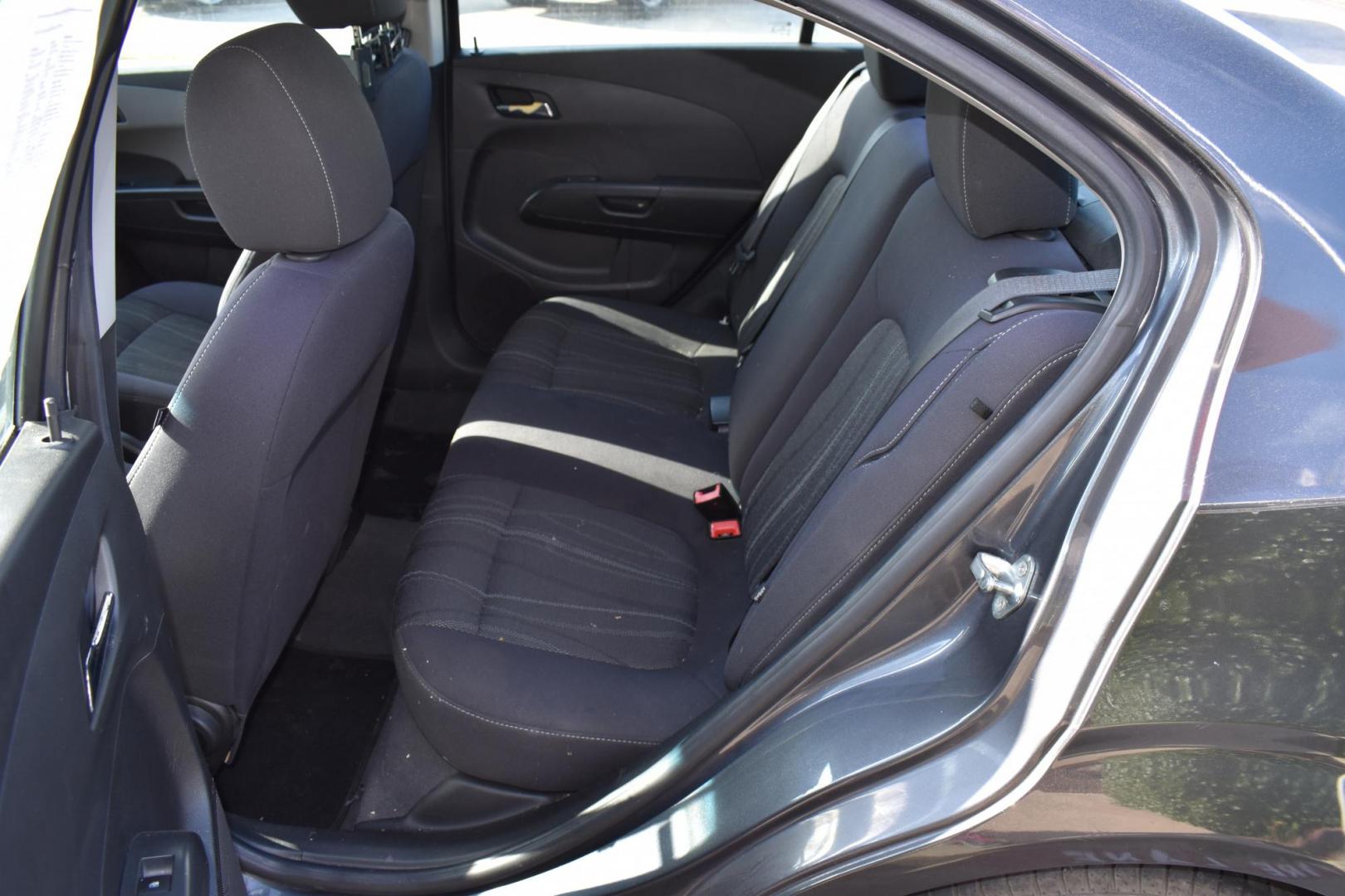 2012 Black /Gray Chevrolet Sonic (1G1JC5SH9C4) with an 4.1.8L engine, 6-Speed Automatic transmission, located at 5925 E. BELKNAP ST., HALTOM CITY, TX, 76117, (817) 834-4222, 32.803799, -97.259003 - The 2012 Chevrolet Sonic offers several benefits. Here are a few: 1. Fuel Efficiency: The Sonic is known for its impressive fuel efficiency, making it a cost-effective choice for daily commuting and long drives. 2. Compact Size: The Sonic's compact size makes it easy to maneuver in tight city stre - Photo#17