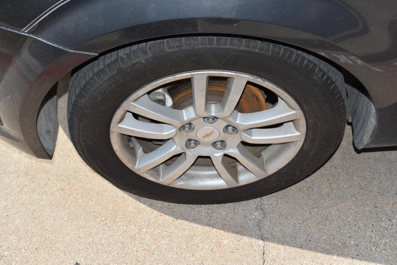 2012 Black /Gray Chevrolet Sonic (1G1JC5SH9C4) with an 4.1.8L engine, 6-Speed Automatic transmission, located at 5925 E. BELKNAP ST., HALTOM CITY, TX, 76117, (817) 834-4222, 32.803799, -97.259003 - The 2012 Chevrolet Sonic offers several benefits. Here are a few: 1. Fuel Efficiency: The Sonic is known for its impressive fuel efficiency, making it a cost-effective choice for daily commuting and long drives. 2. Compact Size: The Sonic's compact size makes it easy to maneuver in tight city stre - Photo#19