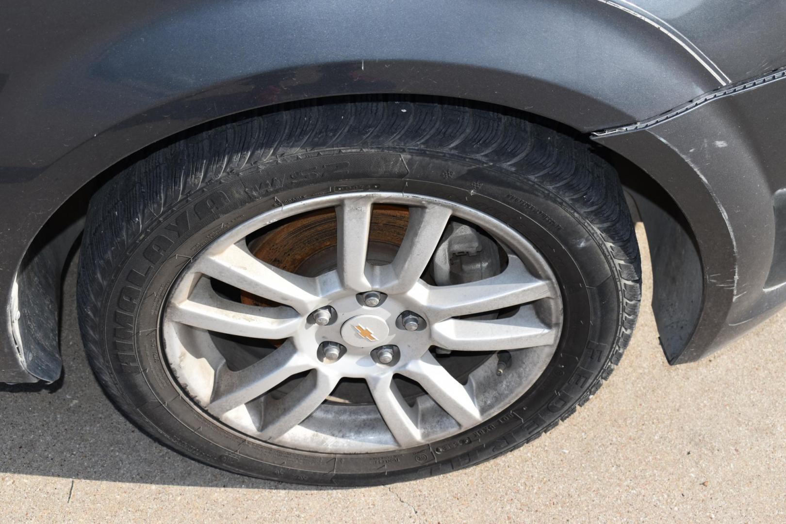 2012 Black /Gray Chevrolet Sonic (1G1JC5SH9C4) with an 4.1.8L engine, 6-Speed Automatic transmission, located at 5925 E. BELKNAP ST., HALTOM CITY, TX, 76117, (817) 834-4222, 32.803799, -97.259003 - The 2012 Chevrolet Sonic offers several benefits. Here are a few: 1. Fuel Efficiency: The Sonic is known for its impressive fuel efficiency, making it a cost-effective choice for daily commuting and long drives. 2. Compact Size: The Sonic's compact size makes it easy to maneuver in tight city stre - Photo#21